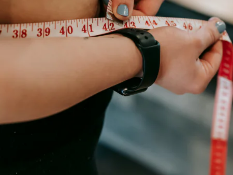 women measuring waist with tape measure weight loss